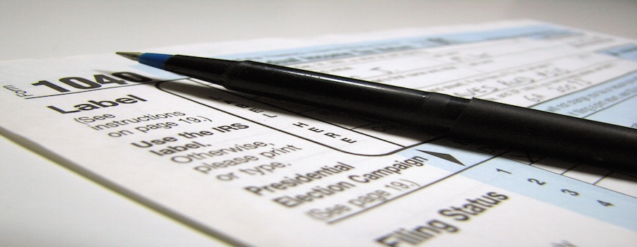 2481-closeup-of-a-1040-tax-form-and-a-pen-or copy
